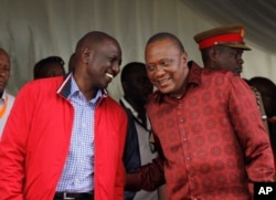 FILE - Kenyan President Uhuru Kenyatta (right) talks with Vice President William Ruto during the unveiling of a cargo train at the Mombasa, Kenya, port containers depot, May 30, 2017.