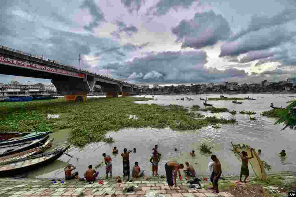People bathe on the banks of Buriganga River during a lockdown imposed by the Bangladesh government to curb the spread of Covid-19 in Dhaka, July 27, 2021.