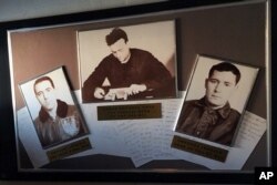 Grainy, black-and-white photos of the captain and captured crew hang in the USS Pueblo in Pyongyang, North Korea, Jan. 24, 2018. The spy ship, on display in Pyongyang, is the only commissioned US Navy ship held by a foreign government.