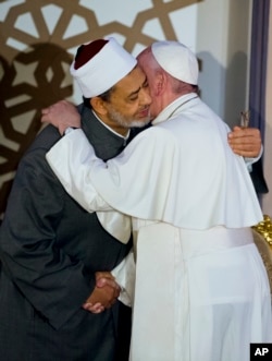 FILE - Pope Francis, right, and Sheikh Ahmed el-Tayeb, Grand Imam of Al-Azhar, hug in Cairo, April 28, 2017. Francis was in Egypt for a two-day trip aimed at presenting a united Christian-Muslim front that repudiates violence committed in God's name.