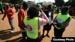 Zimbabwe Electoral Commission officials conducting an election campaign exercise outside Mai Musodzi Hall in Mbare,Harare.