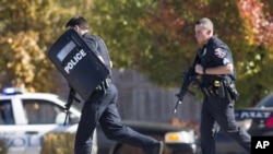 Police and swat team members respond to a call of a shooting at the Azana Spa in Brookfield, Wisconsin on Sunday,Oct. 21, 2012.