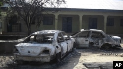 Burnt-out cars are seen at the business and skills center following attacks by the Boko Haram sect in Potiskum, Nigeria, October 20, 2012.