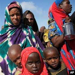 Women and children queue to receive food at a World Food Program distribution center in Mogadishu.