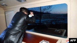 This picture taken on Jan. 11, 2022, and released from North Korea's official Korean Central News Agency on Jan. 12, 2022, shows North Korean leader Kim Jong Un observing what state media says is a hypersonic missile test-fire at an undisclosed location in North Korea. 