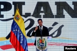 FILE - Venezuelan opposition leader Juan Guaido, who many nations have recognized as the country's rightful interim ruler, speaks during a meeting regarding the condition of the water and electricity systems in Caracas, Venezuela, March 28, 2019.