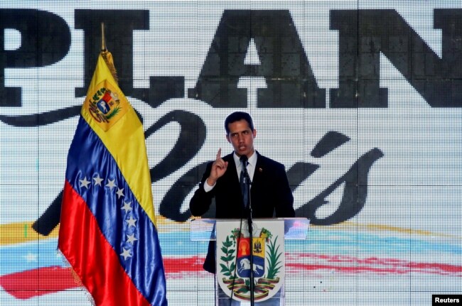 FILE - Venezuelan opposition leader Juan Guaido, who many nations have recognized as the country's rightful interim ruler, speaks during a meeting regarding the condition of the water and electricity systems in Caracas, Venezuela, March 28, 2019.