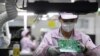 Seorang pekerja tampak mengecek papan sirkuit elektronik pada salah satu bagian produksi di Pabrik Gree, di Wuhan, China, pada 16 Agustus 2021. (Foto: China Daily via Reuters)