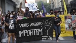 FILE - In this June 11, 2020 file photo, people holding a banner that reads "Black Lives Matter" march during a protest against racism and police violence in Niteroi, Rio de Janeiro, Brazil. (AP Photo/Silvia Izquierdo)