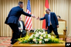 U.S. Ambassador to Vietnam Daniel Kritenbrink, left, shakes hands with Vietnamese Prime Minister Nguyen Xuan Phuc, right, as he meets with Secretary of State Mike Pompeo in Hanoi, Vietnam, Monday, July 9, 2018.