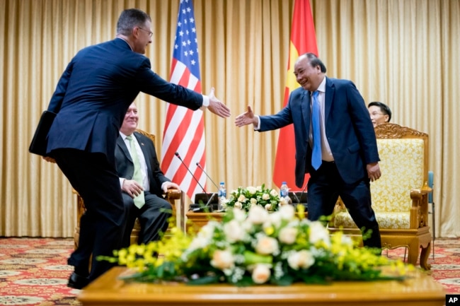 U.S. Ambassador to Vietnam Daniel Kritenbrink, left, shakes hands with Vietnamese Prime Minister Nguyen Xuan Phuc, right, as he meets with Secretary of State Mike Pompeo in Hanoi, Vietnam, Monday, July 9, 2018.