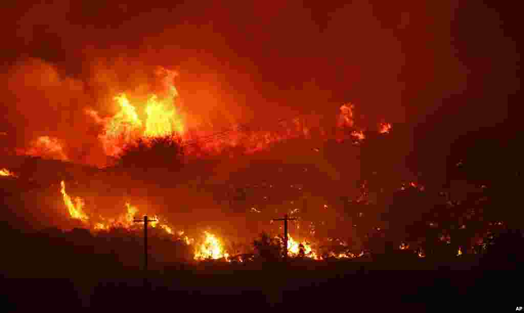 A wildfire burns next to power lines near Othello, Washington.