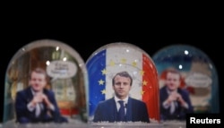 Snowglobes depicting French President Emmanuel Macron, made by Bruot company in eastern France, are displayed at a store in Paris, France, Nov. 17, 2017.