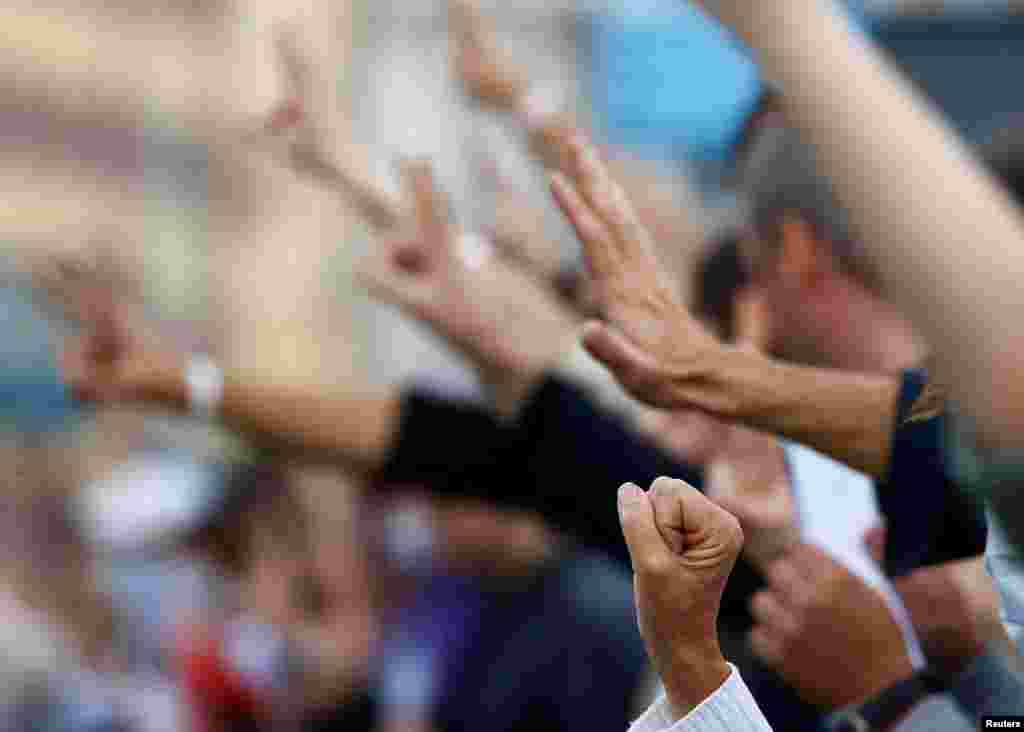 People gesture as they take part in a rally against presidential election results near the National Academy of Sciences of Belarus in Minsk, Belarus.