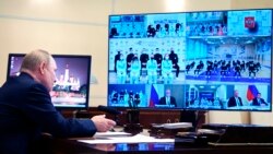 Russian President Vladimir Putin talks with members of Russia's national team ahead of the Beijing 2022 Winter Olympics, via a videoconference at the Novo-Ogaryovo residence outside Moscow, Jan. 25, 2022.
