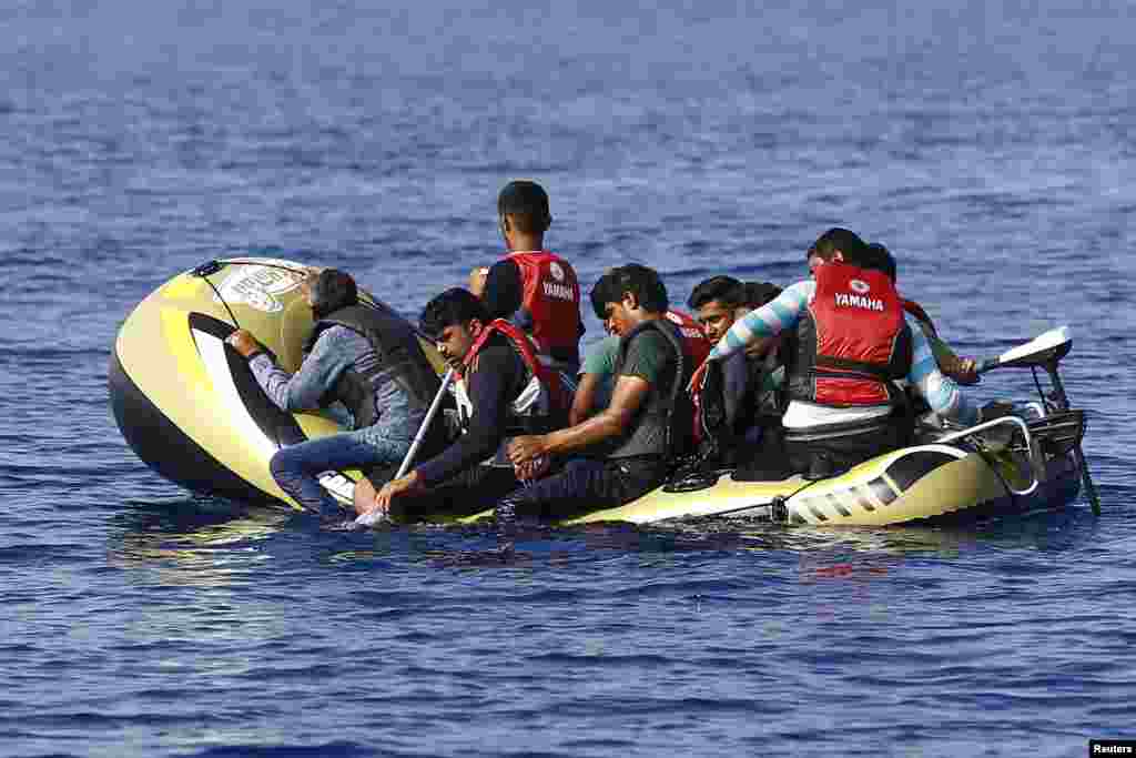 Migrants in a dinghy paddle their craft after leaving Bodrum, Turkey, in the hopes of crossing the Mediterrean Sea to reach the Greek Island of Kos. Of the record total of 432,761 refugees and migrants making the perilous journey across the Mediterranean to Europe so far this year, an estimated 309,000 people had arrived by sea in Greece.