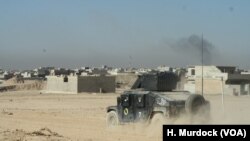 An Iraqi Army vehicle races to the front in Mosul, Iraq, Nov. 19, 2016.