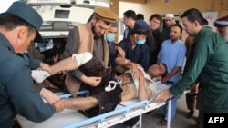 Afghan volunteers transport an injured man on a stretcher to a hospital following a bomb attack on a campaign rally in Afghanistan's northeastern Takhar province, Oct. 13, 2018.