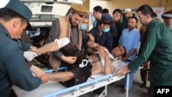 Afghan volunteers transport an injured man on a stretcher to a hospital following a bomb attack on a campaign rally in Afghanistan's northeastern Takhar province, Oct. 13, 2018.