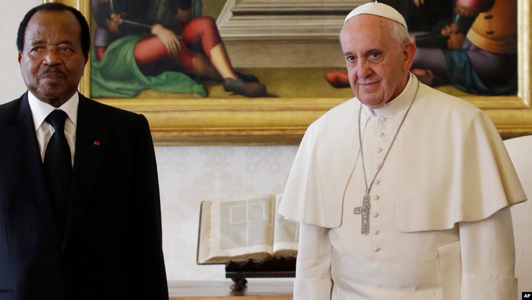 FILE - Pope Francis poses with Cameroon President Paul Biya and his wife Chantal Biya during a private audience at the Vatican, Oct. 18, 2013.