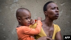 Shireen Louw carries her son, who was one of the nine children infected with listeriosis at the Children's Orientation Centre in Klipspruit West, in Soweto, March 13, 2017. The children from the Centre, all under five years old, were admitted January 12 to Chris Hani Baragwanath Hospital with febrile gastro-enteritis, which was later found to be caused by the food-borne disease listeriosis.