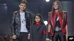 In this Oct. 8, 2011 file photo, from left, Prince Jackson, Prince Michael II "Blanket"Jackson and Paris Jackson arrive on stage at the Michael Forever the Tribute Concert, at the Millennium Stadium in Cardiff, Wales.