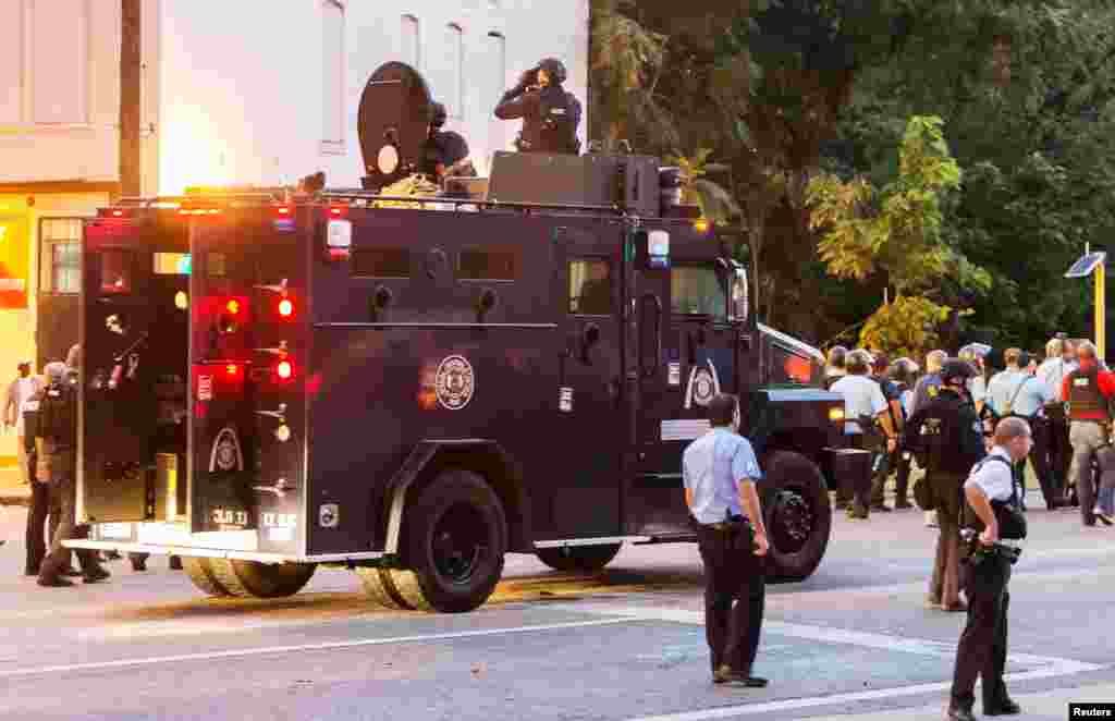 Police watch from an armored car as protesters gather after a shooting incident in St. Louis, Aug. 19, 2015.&nbsp;