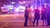 FILE - Orlando Police officers direct family members away from a fatal shooting at Pulse Orlando nightclub in Orlando, Fla. 