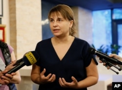 FILE - Olesya Bilousova, chief executive of Intellect Service, which developed M.E.Doc accounting software, speaks to journalists following a discussion on last week's cyberattack in Kyiv, Ukraine, July 5, 2017.