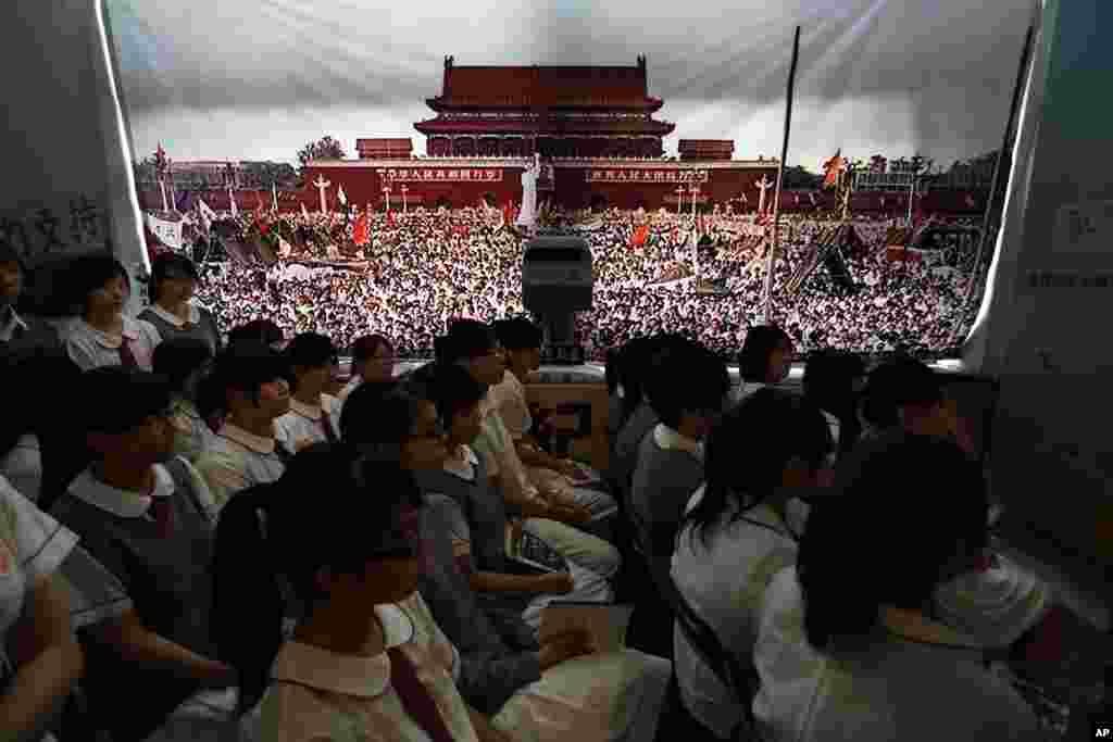 Students watch a video footage of the crackdown of the June 4, 1989 pro-democracy movement in Beijing's Tiananmen Square at the June 4 Memorial Museum run by pro-democracy activists in Hong Kong Monday, June 4, 2012 to commemorate the 23rd anniversary of 