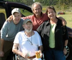 In this Sept. 29, 2009 photo provided by Betsy McNair, Robert McNair, center, poses with his children from left to right, Paul, Mark, and Betsy on the Eastern Shore of Virginia. (Courtesy of Betsy McNair via AP)