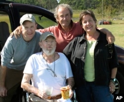 In this Sept. 29, 2009 photo provided by Betsy McNair, Robert McNair, center, poses with his children from left to right, Paul, Mark, and Betsy on the Eastern Shore of Virginia. (Courtesy of Betsy McNair via AP)