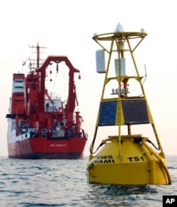 FILE- A buoy, which is a part of a tsunami warning system developed by GITEWS (German-Indonesian Contribution for the Installation of a Tsunami Warning System), floats in on the sea off Java island, Indonesia, Nov. 15, 2005.
