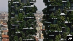 The twin towers of the Bosco Verticale (Vertical Forest) residential buildings at the Porta Nuova district rise above Milan, Italy, on Aug. 3, 2017. Designed by the Boeri studio, it was named "2015 Best Tall Building Worldwide" by the Council on Tall Buildings and Urban Habitat. Boeri has plans to make "forest cities" in China and elsewhere.