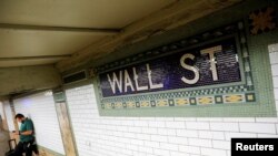 FILE - A person waits on the Wall Street subway platform in the Financial District of Manhattan, New York City, Aug. 20, 2021.