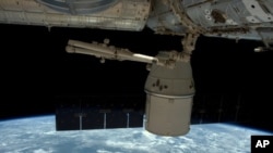 This photo released by NASA shows the SpaceX Dragon undocked from the International Space Station as it is maneuvered for its release, May 11, 2016. 