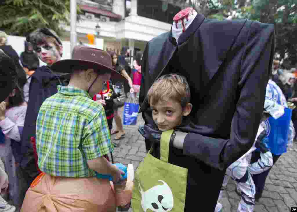 Children dressed for Halloween prepare to trick-or-treat in a housing compound in South Jakarta district in Jakarta, Indonesia.