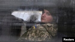 A detained Ukrainian serviceman and crew member of one of Ukrainian naval ships recently seized by Russia's FSB security service looks out of a minibus window outside a court building in Simferopol, Crimea, Nov. 28, 2018.