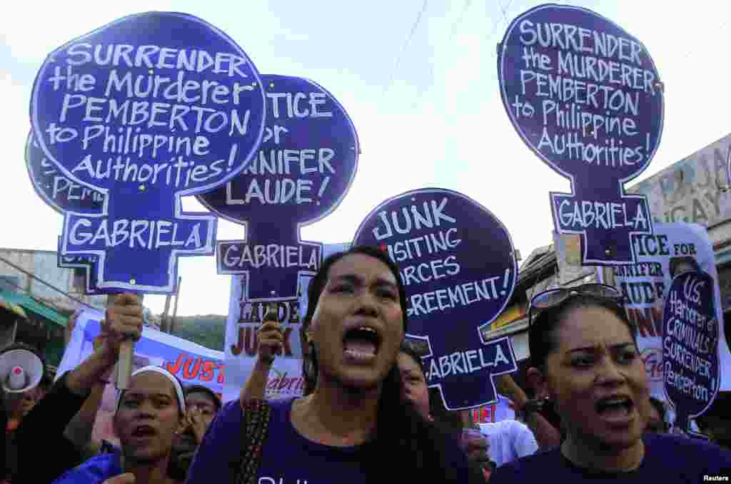Members of the Gabriela Women&#39;s Party, a group advocating the rights of Filipino women, shout, &quot;Justice for slain transgender Jennifer Laude&quot; during a protest outside the Justice Hall, where preliminary investigations into Jennifer Laude&#39;s murder were being held, in Olongapo city, north of Manila, Oct. 21, 2014. 