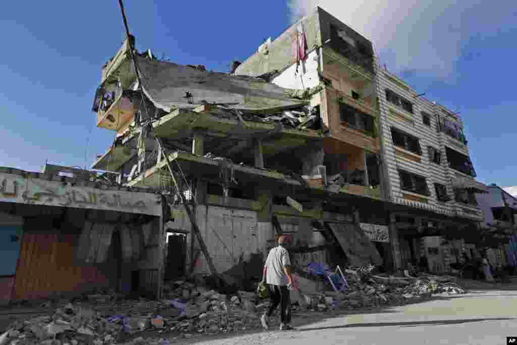 A man walks past the el-Yazje family apartment building which was destroyed following an overnight Israeli missile strike, in Gaza City, July 17, 2014.
