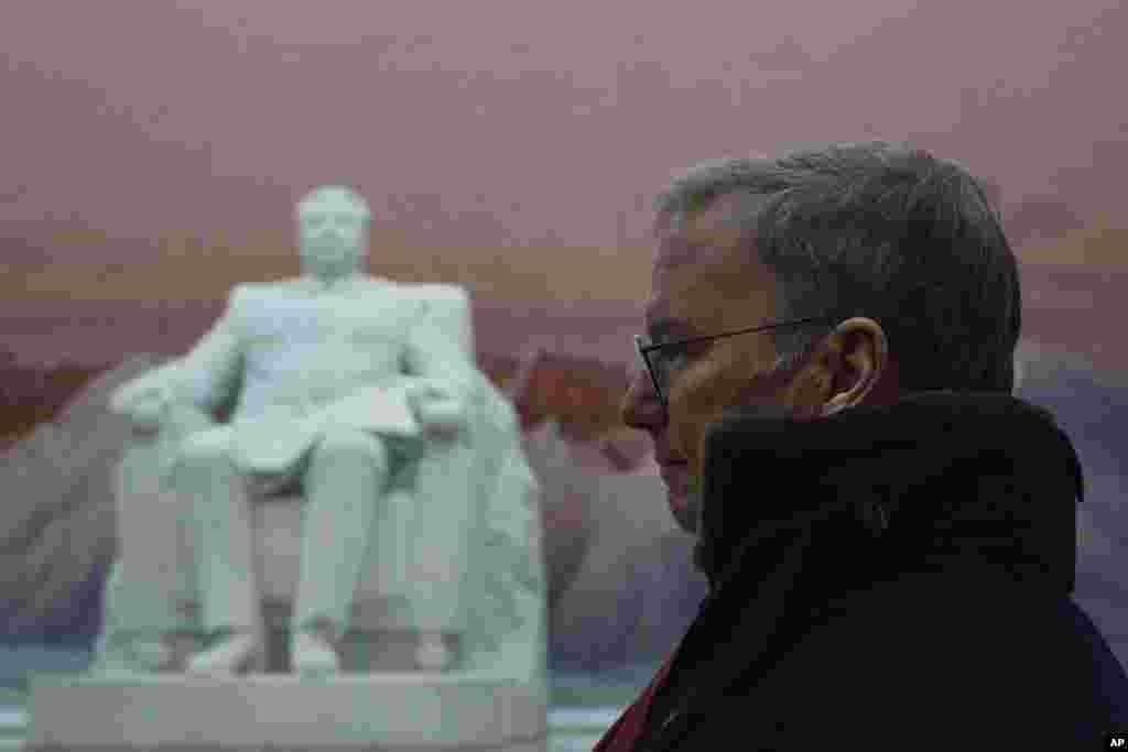 Executive Chairman of Google, Eric Schmidt, stands near a statue of the late North Korean leader Kim Il Sung during a tour of the Grand Peoples Study House in Pyongyang, North Korea. 