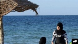 Veiled women sitting on a deck chairs on the beach in Sangho hotel in Zarzia, south Tunisia on July 30, 2010.