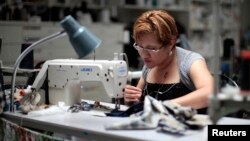 A worker sews clothes at the Karen Kane clothing company in Los Angeles, California, Jun. 30, 2011. The Los Angeles apparel industry is riding a small but growing wave of incoming jobs as costs in China and India rise.