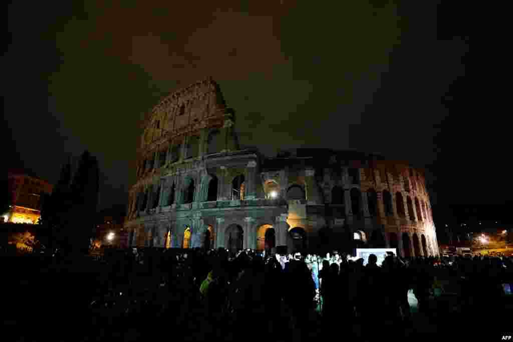 The ancient Colosseum is seen in the dark during the Earth Hour initiative in Rome, Italy, March 24, 2018.