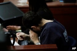 Dr. Larry Nassar wipes his face after a gymnast gave her victim impact statement during the seventh day of his sentencing hearing, Jan. 24, 2018, in Lansing, Mich.