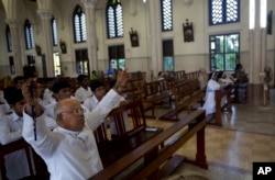 A priest offers prayers with others at the Immaculate Heart of Mary Cathedral in Kottayam in southern Indian state of Kerala, Nov. 4, 2018.