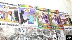 Posters encourage citizens to vote. The second to the left tells people not to accept bribes from political campaigners in exchange for votes, January 23, 2012