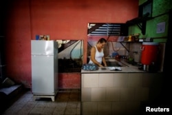 Aridania Rubens works beside a Chinese-made Haier refrigerator at her restaurant in Havana, Feb. 10, 2017.