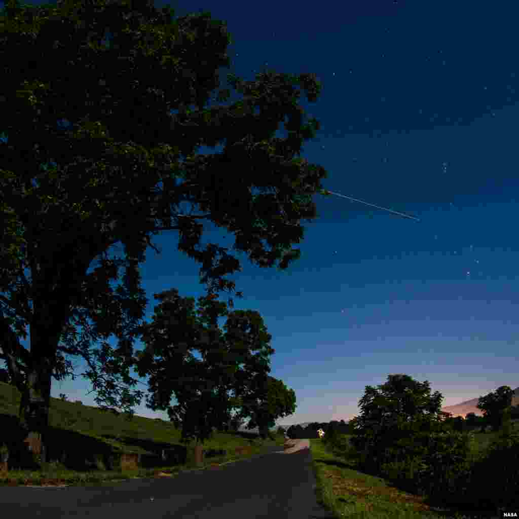 The International Space Station is seen in this 30-second exposure as it flies over Elkton, Virginia, USA, early in the morning on Aug. 1, 2015. (Photo Credit: NASA/Bill Ingalls)