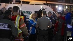 Media gather around Clackamas County sheriff's Lt. James Rhodes during a news conference at the scene of a multiple shooting at Clackamas Town Center Mall in Clackamas, Ore., Tuesday Dec. 11, 2012.